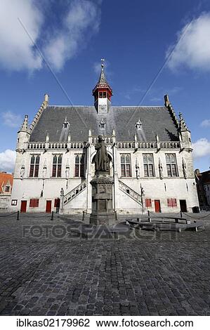 Stock Image - Historic City Hall and a Memorial to Jacob van Maerlant, Grote Markt square, Damme, West Flanders, Belgium, Europe. Fotosearch