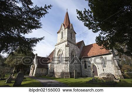 Stock Image - Holy Trinity Church, English country village church with spire and church yard, Horndean, Hampshire, England, United Kingdom, Europe. Fotosearch