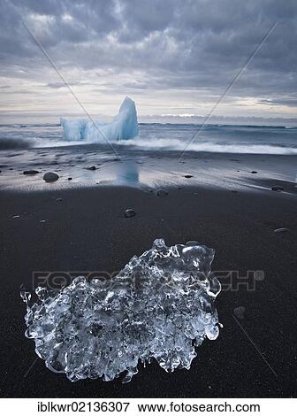 Iceberg and an ice crystal on a black beach, Joekulsarlon, Vatnajokull Glacier, Iceland, Europe View Large Photo Image Stock Photo - Iceberg and an ice crystal on a black beach, Joekulsarlon, Vatnajokull Glacier, Iceland, Europe. Fotosearch