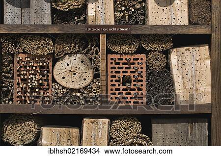 Picture - Insect house, insect hotel with notice "Bitte die Tiere nicht stoeren! ", German for "Please do not disturb the animals! ", North Rhine-Westphalia, Germany, Europe. Fotosearch