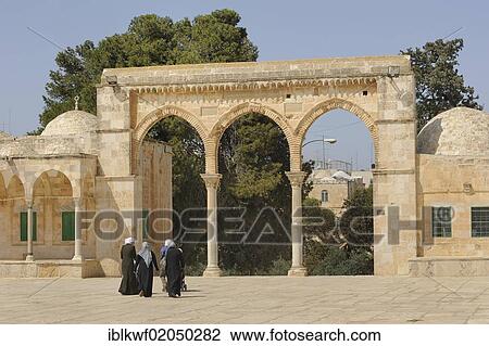 Stock Image - Israeli Palestinian women on the Temple Mount approaching the arcades with Byzantine columns, Al-Mawazin, Muslim Quarter, Old City, Jerusalem, Israel, Middle East, Asia. Fotosearch