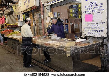 Stock Photo - Jewish man wearing a kippah buying nuts at the Mahane Yehuda market from a Jewish merchant, Jaffa Road, Jerusalem, Israel, Middle East, Southwest Asia, Asia. Fotosearch