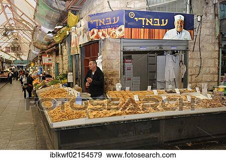 Stock Photo - Jewish vendor offering a variety of baked goods for sale on a stall at the Jewish Mahane Yehuda market, Jaffa Road, Jerusalem, Israel, Middle East, Southwest Asia, Asia. Fotosearch