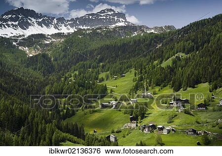 Landscape with a mountain village below the mountain peaks of the Dolomites, Italy, Europe View Large Photo Image Stock Photograph - Landscape with a mountain village below the mountain peaks of the Dolomites, Italy, Europe. Fotosearch
