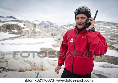 Leader of a group of hikers using a satellite phone, at Mittivakkat Glacier, Ammassalik Peninsula, East Greenland, Greenland, North America View Large Photo Image Stock Image - Leader of a group of hikers using a satellite phone, at Mittivakkat Glacier, Ammassalik Peninsula, East Greenland, Greenland, North America. Fotosearch