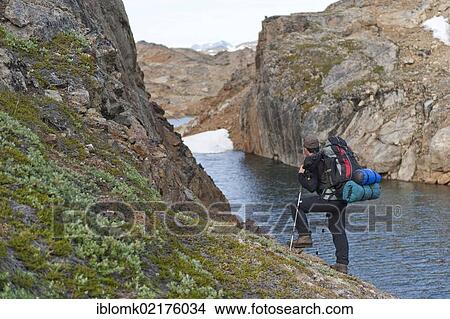 Leader of a group of hikers with a backpack and a rifle, Ammassalik Peninsula, East Greenland, Greenland, North America View Large Photo Image Picture - Leader of a group of hikers with a backpack and a rifle, Ammassalik Peninsula, East Greenland, Greenland, North America. Fotosearch