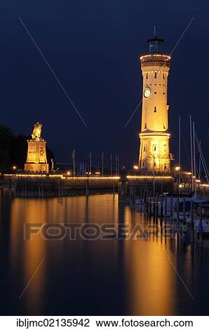 Stock Image - Lighthouse and Bavarian Lion at the harbor entrance, Lindau, Bodensee, Lake Constance, Bavaria, Germany, Europe. Fotosearch