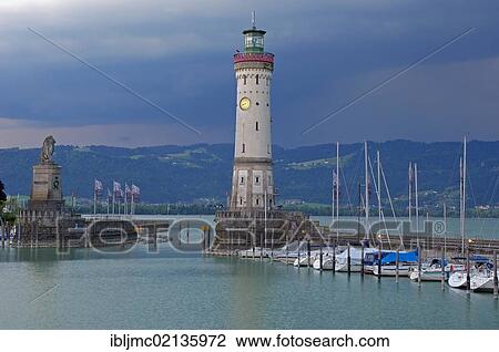 Stock Image - Lighthouse and Bavarian Lion at the harbor entrance, Lindau, Bodensee, Lake constance, Bavaria, Germany, Europe. Fotosearch