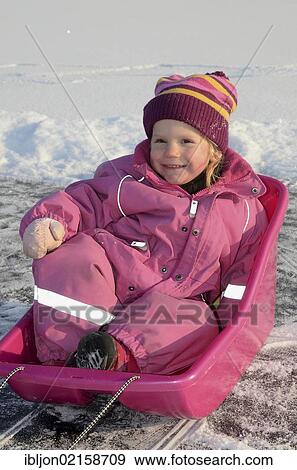 Little girl, two years, in a pink sledge, Hedeskoga, Skåne, Skane, Sweden, Europe View Large Photo Image Stock Photo - Little girl, two years, in a pink sledge, Hedeskoga, Skåne, Skane, Sweden, Europe. Fotosearch