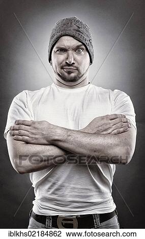 Stock Image - Man in a macho pose, edited portrait. Fotosearch