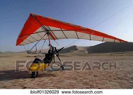 Microlight aircraft in front of the sand dunes of the Gobi Desert and Mount Mingshan near Dunhuang, Silk Road, Gansu, China, Asia View Large Photo Image Stock Photo - Microlight aircraft in front of the sand dunes of the Gobi Desert and Mount Mingshan near Dunhuang, Silk Road, Gansu, China, Asia. Fotosearch