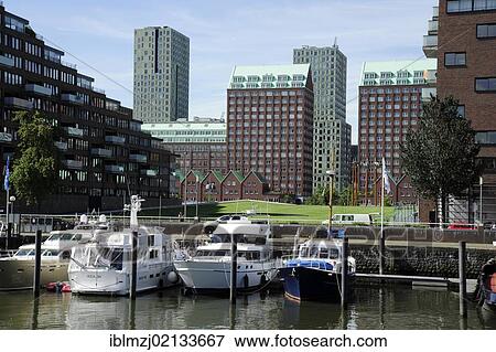 Stock Photo - Modern architecture along the Nieuwe Maas River, boats in Entrepothaven Harbour, Kop van Zuid, Rotterdam, Holland, Nederland, Netherlands, Europe. Fotosearch