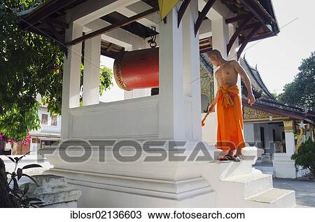 Monk drumming at the Wat Sop Sickharam Temple, Luang Prabang, UNESCO World Heritage Site, Laos, Indochina, Asia View Large Photo Image Stock Image - Monk drumming at the Wat Sop Sickharam Temple, Luang Prabang, UNESCO World Heritage Site, Laos, Indochina, Asia. Fotosearch