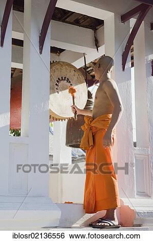 Monk drumming at the Wat Sop Sickharam Temple, Luang Prabang, UNESCO World Heritage Site, Laos, Indochina, Asia View Large Photo Image Stock Photograph - Monk drumming at the Wat Sop Sickharam Temple, Luang Prabang, UNESCO World Heritage Site, Laos, Indochina, Asia. Fotosearch