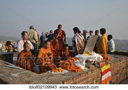 Stock Image - Monks and Buddhist dignitaries from Laos, Burma, Cambodia, Korea, Tibet, from all Buddhist traditions and schools gather for a communal prayer at Buddha's first place of activity and meditation sites, Vulture Peak, important Buddhist pilgrimage.... Fotosearch