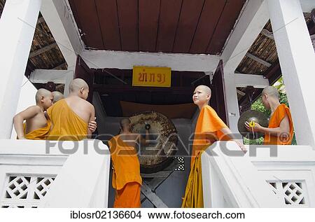 Monks drumming at the temple, Luang Prabang, UNESCO World Heritage Site, Laos, Indochina, Asia View Large Photo Image Picture - Monks drumming at the temple, Luang Prabang, UNESCO World Heritage Site, Laos, Indochina, Asia. Fotosearch