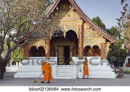 Picture - Monks sweeping the temple in the morning, Wat Sibounheuang, Luang Prabang, UNESCO World Heritage Site, Laos, Indochina, Asia. Fotosearch