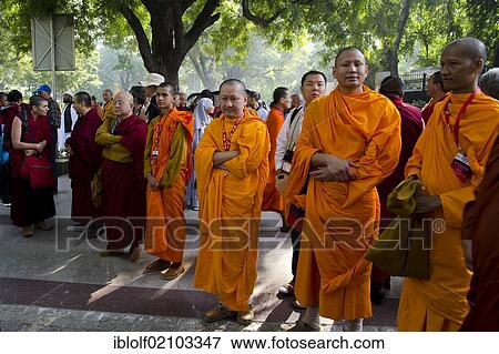 Monks wearing red and orange robes and Buddhist dignitaries from Laos, Burma, Myanmar, Cambodia, Korea, Tibet from all Buddhist traditions and schools at a meeting for communal prayer, Global Buddhist Congregation 2011, Gandhi Smitri, New Delhi,... View Large Photo Image Stock Photo - Monks wearing red and orange robes and Buddhist dignitaries from Laos, Burma, Myanmar, Cambodia, Korea, Tibet from all Buddhist traditions and schools at a meeting for communal prayer, Global Buddhist Congregation 2011, Gandhi Smitri, New Delhi,.... Fotosearch