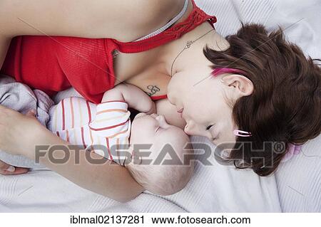 Mother holding her sleeping baby in her arms View Large Photo Image Stock Image - Mother holding her sleeping baby in her arms. Fotosearch