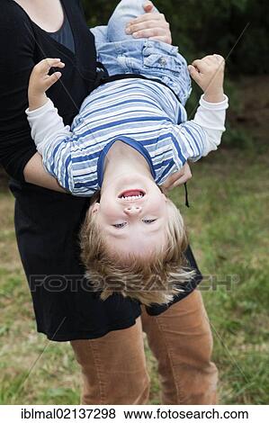Stock Photo - Mother swirling her two year old son through the air. Fotosearch