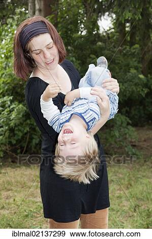 Stock Photo - Mother swirling her two year old son through the air. Fotosearch