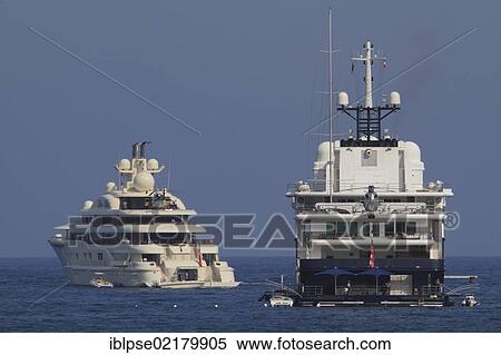 Motor yacht "Le Grand Bleu", 112. 80m, built in 2000 by Bremer Vulcan, architecture and exterior design by Kusch Yachts, with motor yacht Dilbar, Côte d'Azur, France, Mediterranean, Europe View Large Photo Image Stock Photography - Motor yacht "Le Grand Bleu", 112. 80m, built in 2000 by Bremer Vulcan, architecture and exterior design by Kusch Yachts, with motor yacht Dilbar, Côte d'Azur, France, Mediterranean, Europe. Fotosearch