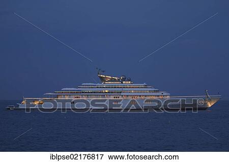 Stock Photo - Motor yacht "Rising Sun", 138m, at night, built by Luersson Yachts in 2004, owned by David Geffen, previously owned by Larry Ellison, Côte d'Azur, France, Mediterranean, Europe. Fotosearch