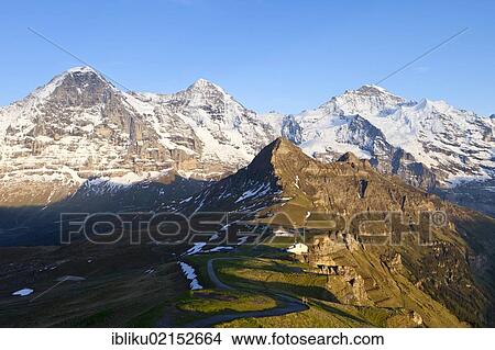 Mountains Eiger, Moench and Jungfrau, Maennlichen mountain restaurant, view from Maennlichen, Bernese Oberland, Switzerland, Europe View Large Photo Image Picture - Mountains Eiger, Moench and Jungfrau, Maennlichen mountain restaurant, view from Maennlichen, Bernese Oberland, Switzerland, Europe. Fotosearch