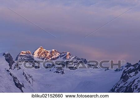 Stock Image - Mt Jungfrau and Jungfraujoch in the morning light, Valais, Bernese Oberland, Switzerland, Europe. Fotosearch