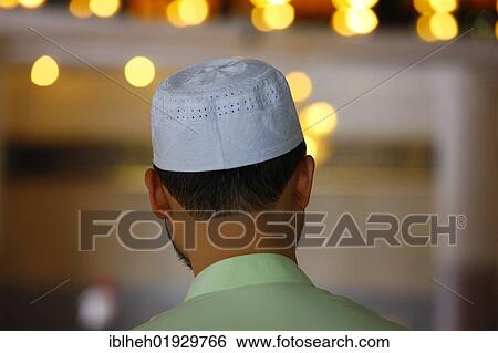Stock Photograph - Muslim man, rear view, National Mosque, Kuala Lumpur, Malaysia, Southeast Asia, Asia. Fotosearch