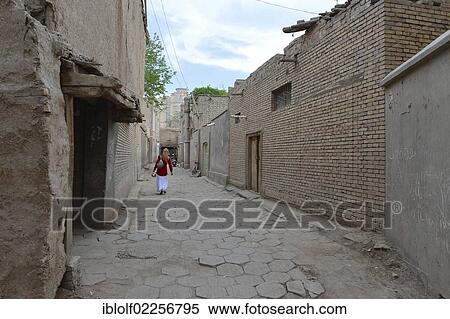 Muslim woman walking though an alleyway in the old town of the Uyghur quarter, old adobe brick architecture, Silk Road, Kashgar, Xinjiang, China, Asia View Large Photo Image Stock Photography - Muslim woman walking though an alleyway in the old town of the Uyghur quarter, old adobe brick architecture, Silk Road, Kashgar, Xinjiang, China, Asia. Fotosearch