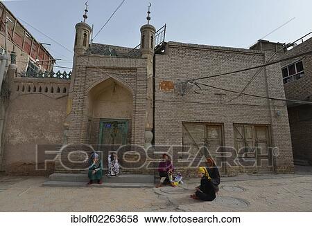 Muslim women, Uighurs with colourful headscarves sitting in front of a mosque, mud-brick houses, Uighur historic centre of Kashgar, Silk Road, Xinjiang, China, Asia View Large Photo Image Stock Photo - Muslim women, Uighurs with colourful headscarves sitting in front of a mosque, mud-brick houses, Uighur historic centre of Kashgar, Silk Road, Xinjiang, China, Asia. Fotosearch