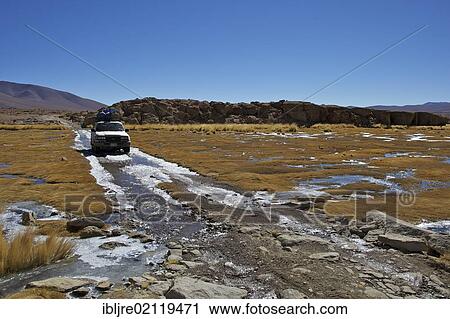 Off-road vehicle driving through an icy ford, Altiplano, Potosi, southern Bolivia, South America View Large Photo Image Stock Image - Off-road vehicle driving through an icy ford, Altiplano, Potosi, southern Bolivia, South America. Fotosearch