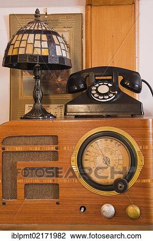 Old telephone and radio in the music listening room inside an old 1904 Victorian cottage style residential home, Quebec, Canada, North America View Large Photo Image Stock Image - Old telephone and radio in the music listening room inside an old 1904 Victorian cottage style residential home, Quebec, Canada, North America. Fotosearch