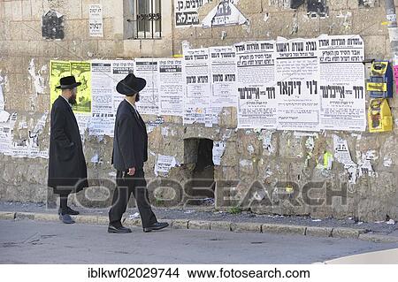 Orthodox Jews reading wall newspapers in the district of Me'a She'arim or Mea Shearim, Jerusalem, Israel, Middle East, Asia View Large Photo Image Picture - Orthodox Jews reading wall newspapers in the district of Me'a She'arim or Mea Shearim, Jerusalem, Israel, Middle East, Asia. Fotosearch