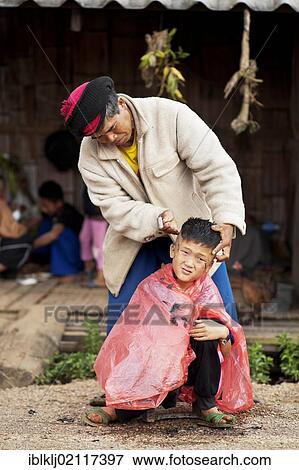 Palong boy getting a haircut at the roadside in Norlae village, northern Thailand, Asia View Large Photo Image Stock Photo - Palong boy getting a haircut at the roadside in Norlae village, northern Thailand, Asia. Fotosearch