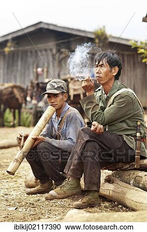 Palong hill tribe men smoking in Norlae village, northern Thailand, Asia View Large Photo Image Stock Image - Palong hill tribe men smoking in Norlae village, northern Thailand, Asia. Fotosearch