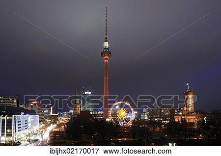 Stock Photo - Panoramic view of the Berlin skyline at night at Christmas time, with the Ferris wheel at the Christmas market, TV tower, Marienkirche church, Park Inn Hotel, Rotes Rathaus, Red City Hall, Berlin, Germany, Europe. Fotosearch