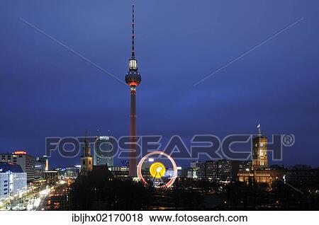 Stock Photo - Panoramic view of the Berlin skyline at night at Christmas time, with the Ferris wheel at the Christmas market, TV tower, Marienkirche church, Park Inn Hotel, Rotes Rathaus, Red City Hall, Berlin, Germany, Europe. Fotosearch