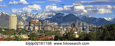 Stock Photo - Panoramic view of the Salt Lake City skyline and the snow-covered Wasatch Mountains at back, Utah, USA, North America. Fotosearch