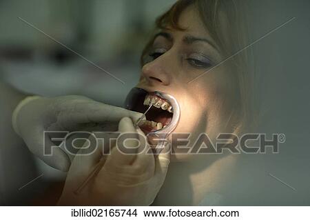 Patient is having a brace fitted at the dentist's View Large Photo Image Picture - Patient is having a brace fitted at the dentist's. Fotosearch