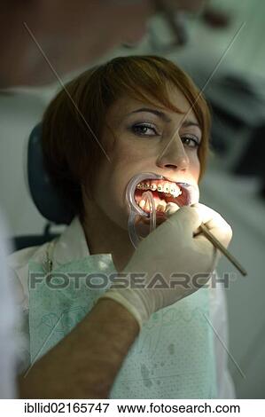 Patient is having a brace fitted at the dentist's View Large Photo Image Stock Photo - Patient is having a brace fitted at the dentist's. Fotosearch