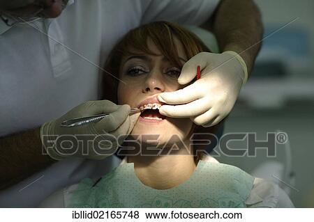 Patient is having a brace fitted at the dentist's View Large Photo Image Stock Photo - Patient is having a brace fitted at the dentist's. Fotosearch