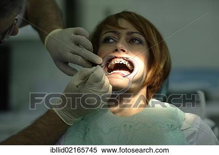 Stock Photography - Patient is having a brace fitted at the dentist's. Fotosearch