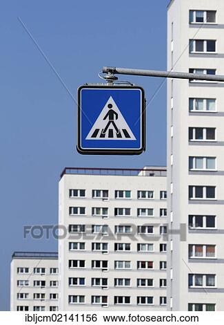Pedestrian crossing sign in front of apartment buildings View Large Photo Image Stock Photograph - Pedestrian crossing sign in front of apartment buildings. Fotosearch