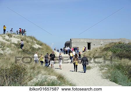 Stock Photo - People walking amongst the dunes, German bunker from the Second World War, Skagen, Jutland, Denmark, Europe. Fotosearch