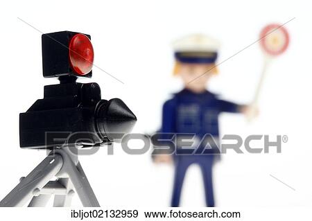Stock Photo - Playmobil figure, a policeman wearing a blue uniform, stop sign and a police radar device to measure the speed of vehicles, traffic control, symbolic image. Fotosearch