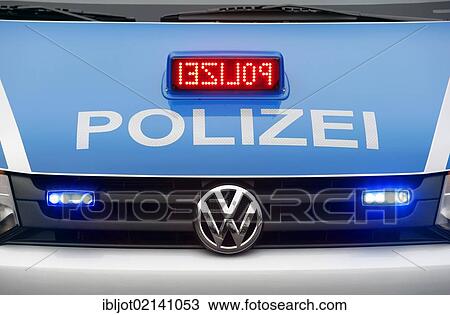 Stock Image - Police patrol car, VW Bully Transporter, labelled Polizei with blue flashing lights and LED scrolling text, POLIZEI, Germany, Europe. Fotosearch