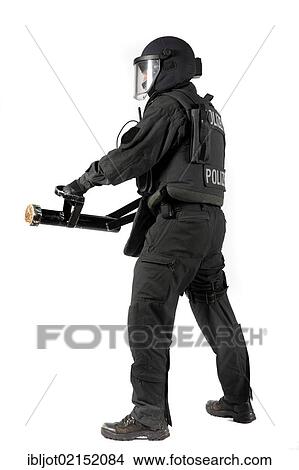 Police, Special Task Force, SEK, officer holding a metal battering ram for the forced entry of doors and windows View Large Photo Image Picture - Police, Special Task Force, SEK, officer holding a metal battering ram for the forced entry of doors and windows. Fotosearch