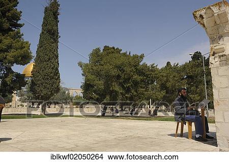 Picture - Praying Palestinian man sitting at a corner of the Al-Aqsa Mosque on the Temple Mount, Muslim Quarter, Old City, Jerusalem, Israel, Middle East, Asia. Fotosearch
